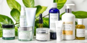 Skincare products for oily skin on a marble surface.