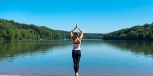 A person doing yoga by a peaceful lake.